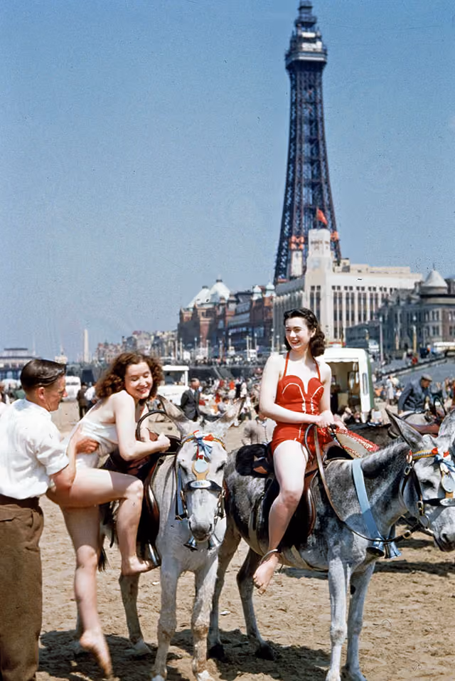 circa 1950: Holiday-makers riding donkeys on the beach at Blackpool. Blackpool Tower is in the background. Original Publication: Picture Post - 7227 - Blackpool - pub. 1954 (Photo by John Chillingworth/Picture Post/Getty Images)